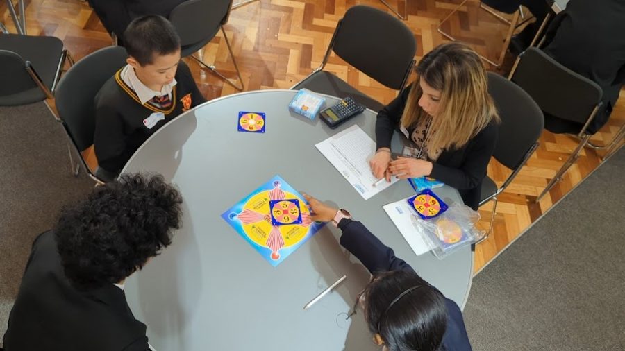 A group of children playing the 24 Game around a table.