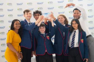 The Jack Petchey Foundation Count On Us Secondary Maths Challenge winners for 2022 pose with their Jack Petchey Foundation-branded trophy, in front of a similarly branded backdrop.
