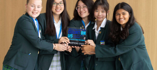 The Holy Cross School posing with their Champions trophy at the Count on Us Secondary Maths Challenge 2023 Grand Final.