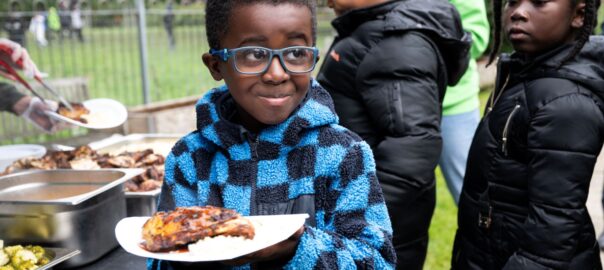 Young person holds plate of food